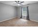 Neutral bedroom with a ceiling fan, carpet, and natural light streaming through the window at 219 Riverbrook Ct, Mcdonough, GA 30252