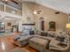 Bright living room featuring a large sectional, fireplace, and hardwood floors at 219 Riverbrook Ct, Mcdonough, GA 30252