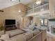Spacious living room with high ceilings, fireplace, comfortable sectional, and second-story balcony at 219 Riverbrook Ct, Mcdonough, GA 30252