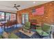 Inviting covered patio with an American flag, comfortable seating, and dining space at 219 Riverbrook Ct, Mcdonough, GA 30252