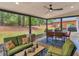 Covered patio with comfortable seating, a dining table, and a serene backyard view at 219 Riverbrook Ct, Mcdonough, GA 30252