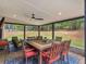 Covered patio with an elegant outdoor dining table and seating area at 219 Riverbrook Ct, Mcdonough, GA 30252