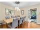 Dining room with rustic table, upholstered chairs and screened porch at 380 Amberidge Trl, Atlanta, GA 30328