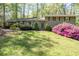 Charming home featuring a lush lawn, blooming azaleas, and a convenient covered carport at 380 Amberidge Trl, Atlanta, GA 30328