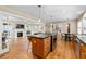 Open-concept kitchen flowing into a spacious living room with a fireplace and ample seating at 380 Amberidge Trl, Atlanta, GA 30328