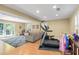 Open-concept living area with hardwood floors, rec lighting, and exercise equipment at 380 Amberidge Trl, Atlanta, GA 30328