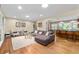 Spacious living room with hardwood floors, modern furnishings, and open to the kitchen island seating at 380 Amberidge Trl, Atlanta, GA 30328