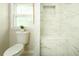 Modern bathroom featuring elegant marble tile and bright window at 104 Holcomb Ferry Rd, Roswell, GA 30076