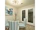 Stylish dining area with modern lighting, glass doors to the patio, and striped chairs at 104 Holcomb Ferry Rd, Roswell, GA 30076