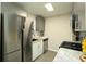 A cozy kitchen with a stainless steel refrigerator and a marble countertop at 104 Holcomb Ferry Rd, Roswell, GA 30076
