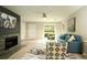 Bright living room with a modern fireplace, stylish furnishings, and a view to the patio at 104 Holcomb Ferry Rd, Roswell, GA 30076