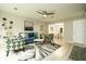 Open-concept living room with stylish decor, fireplace, and seamless flow to the dining area at 104 Holcomb Ferry Rd, Roswell, GA 30076