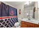 Charming bathroom featuring nautical decor, vanity with storage, and a shower with a decorative curtain at 272 William Nye Se Dr, Atlanta, GA 30315