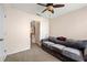 Inviting bedroom featuring a cozy gray sofa, carpet, and a window with natural light at 272 William Nye Se Dr, Atlanta, GA 30315