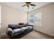 Comfortable bedroom with a gray sofa, carpet flooring, and a window providing natural light at 272 William Nye Se Dr, Atlanta, GA 30315