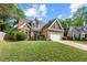 Beautiful brick home boasts well-maintained lawn, two-car garage, and inviting curb appeal at 272 William Nye Se Dr, Atlanta, GA 30315