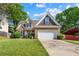 Charming two-story home with brick facade, manicured lawn, and attached two-car garage at 272 William Nye Se Dr, Atlanta, GA 30315