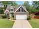 Charming two-story home with brick facade, manicured lawn, and attached two-car garage at 272 William Nye Se Dr, Atlanta, GA 30315