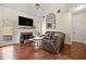 Cozy living room with hardwood floors, fireplace, and comfortable leather seating at 272 William Nye Se Dr, Atlanta, GA 30315