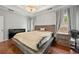 Serene main bedroom with tray ceiling, hardwood floors, large windows, and neutral color palette at 272 William Nye Se Dr, Atlanta, GA 30315