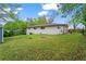 Spacious backyard with a well-maintained lawn and white brick house exterior at 605 Rocky Branch Rd, Villa Rica, GA 30180