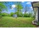Expansive backyard with lush green grass and storage shed provides ample space for outdoor activities at 605 Rocky Branch Rd, Villa Rica, GA 30180