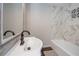 Bright bathroom featuring a stylish vanity, modern fixtures, and a beautifully tiled shower-tub combo at 605 Rocky Branch Rd, Villa Rica, GA 30180