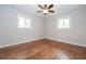 Bright bedroom featuring hardwood floors, neutral paint, and natural light at 605 Rocky Branch Rd, Villa Rica, GA 30180