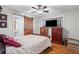 Bedroom with hardwood floors, barn door to bathroom, and natural light at 605 Rocky Branch Rd, Villa Rica, GA 30180