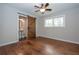 Bedroom featuring rustic barn door to bathroom and hardwood flooring at 605 Rocky Branch Rd, Villa Rica, GA 30180