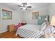 Bedroom featuring hardwood floors, two windows, and charming decor at 605 Rocky Branch Rd, Villa Rica, GA 30180