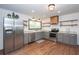 Updated kitchen with gray cabinets, stainless steel appliances, floating shelves, and granite counters at 605 Rocky Branch Rd, Villa Rica, GA 30180