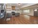 Bright kitchen featuring gray cabinets, stainless appliances, granite counters, and new wood floors at 605 Rocky Branch Rd, Villa Rica, GA 30180