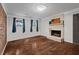 Cozy room showcasing hardwood floors, fireplace and natural light from windows at 605 Rocky Branch Rd, Villa Rica, GA 30180