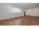 Inviting living room features gleaming hardwood floors, a large window, and neutral walls at 605 Rocky Branch Rd, Villa Rica, GA 30180