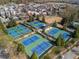 Aerial view featuring a neighborhood with multiple tennis courts for recreation and enjoyment at 7515 Cordery Rd, Cumming, GA 30040