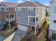 Aerial view of a two-story home with a garage and small balcony in a residential neighborhood at 7515 Cordery Rd, Cumming, GA 30040