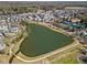 Aerial view of a community lake surrounded by walking paths and residential homes at 7515 Cordery Rd, Cumming, GA 30040