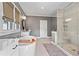 Bathroom with large glass enclosed shower, standalone tub, and modern fixtures at 7515 Cordery Rd, Cumming, GA 30040