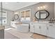 Modern bathroom with a standalone tub, double vanities, and decorative mirrors at 7515 Cordery Rd, Cumming, GA 30040