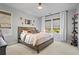 Comfortable bedroom with neutral tones, natural light, and minimalist decor at 7515 Cordery Rd, Cumming, GA 30040