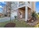 Exterior of a well-maintained home featuring a two-car garage and covered patio with brick accents at 7515 Cordery Rd, Cumming, GA 30040