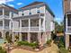 Rear exterior of home with two levels of porches, a manicured yard and combination of brick and siding at 7515 Cordery Rd, Cumming, GA 30040