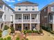 Charming two-story home features a landscaped front yard, a covered porch, and a combination of brick and siding at 7515 Cordery Rd, Cumming, GA 30040