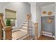 Elegant staircase with hardwood steps, iron railings, and stylish decor at 7515 Cordery Rd, Cumming, GA 30040