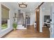 Bright foyer with hardwood floors, staircase, and a stylish sliding barn door at 7515 Cordery Rd, Cumming, GA 30040