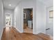 Hallway view shows the laundry room, hardwood floors, and access to other areas of the home at 7515 Cordery Rd, Cumming, GA 30040