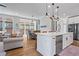 Spacious kitchen with stainless steel appliances, a large island, and an open layout leading to the living area at 7515 Cordery Rd, Cumming, GA 30040