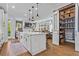 Bright kitchen features a large island with a white countertop and a walk-in pantry with sliding doors at 7515 Cordery Rd, Cumming, GA 30040