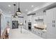 Modern kitchen with stainless steel appliances, a spacious island, and sleek white cabinets at 7515 Cordery Rd, Cumming, GA 30040